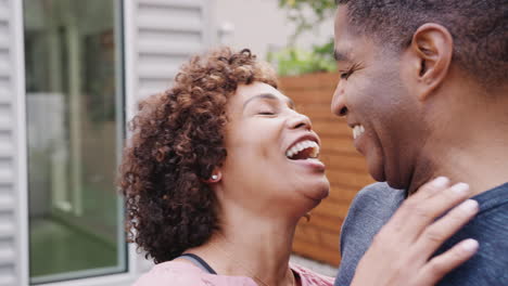 Happy-middle-aged-black-couple-talking-and-embracing-outdoors,-close-up