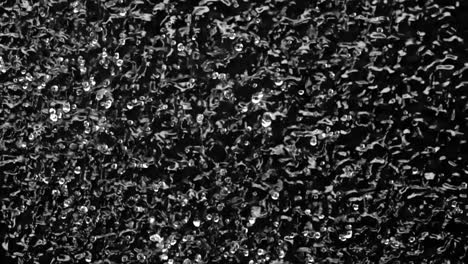water under the influence of vibration and air bubbles in dark water water under the action of ultrasonic vibrations and air bubbles in the dark water black background slow motion