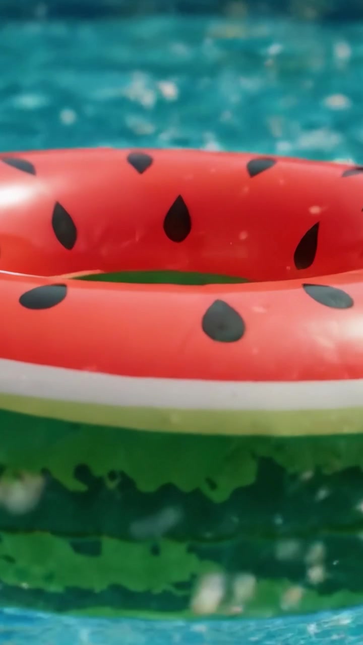 A Bright and Colorful Watermelon Floaty Ring Perfect for Summer Fun in the Pool, Adding a Fun Pop of Color to Your Swimming Experience
