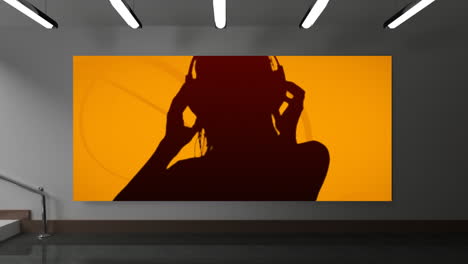 woman dancing with headphones against orange background