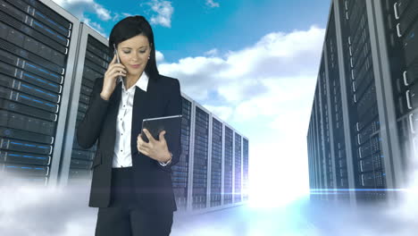 businesswoman having phone call and holding tablet computer in server tower store