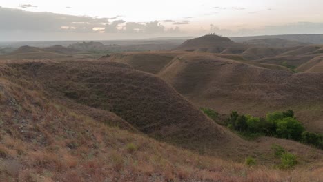 panoramic view of rolling dry hills at dusk