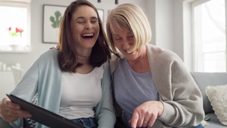 Two-woman-having-fun-during-looking-old-photo-album-together