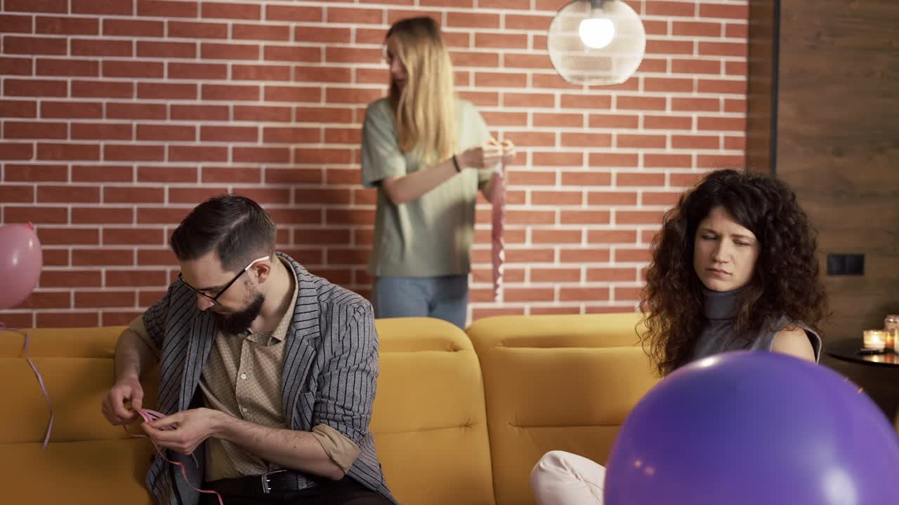 긍정적인 백인 남성과 여성이 즐겁게 준비하고 실내에서 파티를 하고 있습니다.