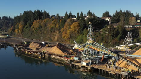 daylight, backward aerial dolly from lumber mill in pacific northwest