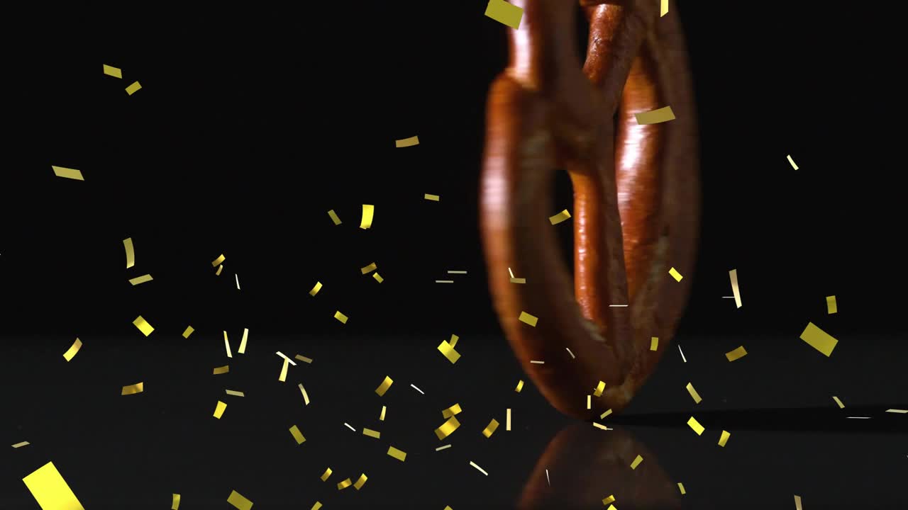 Pretzel jatuh dari atas, berputar, memantul, konfeti emas berputar-putar, menunjukkan kulit yang mengkilap