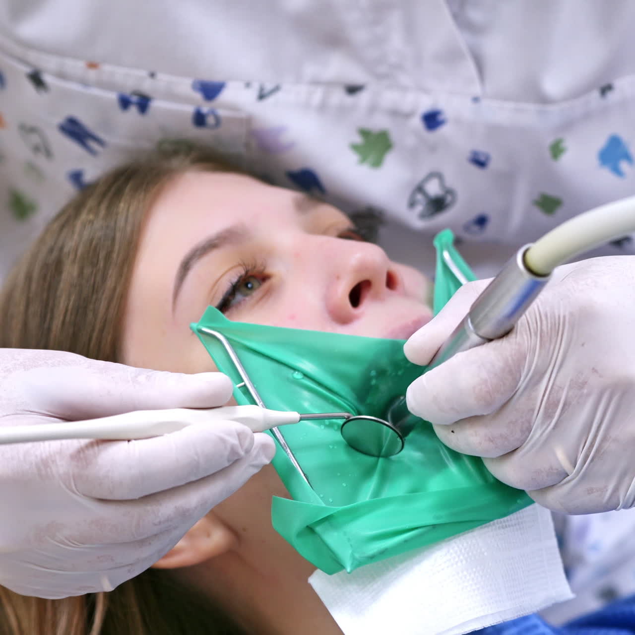 Doctor treats patient teeth in modern dental clinic