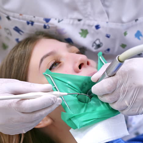 doctor treats patient teeth in modern dental clinic