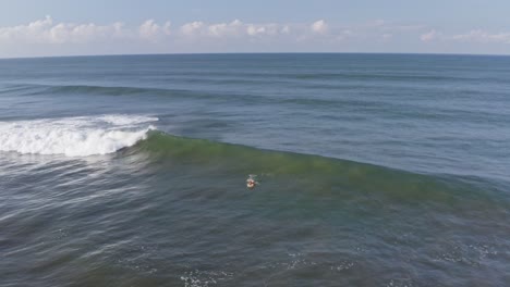 aerial: surfer attempting to catch a big wave, then pulling out