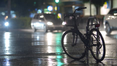 bicycle parked on the street during rainy evening