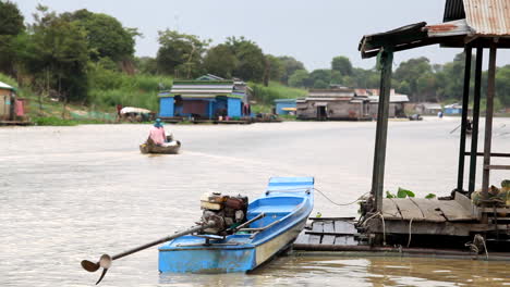 small boat on a floating village in cambodia