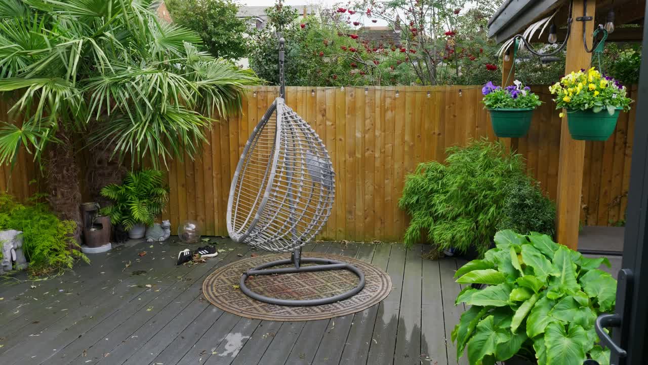 Minimalistic English garden with modern decking bamboo plants on a windy breezy day