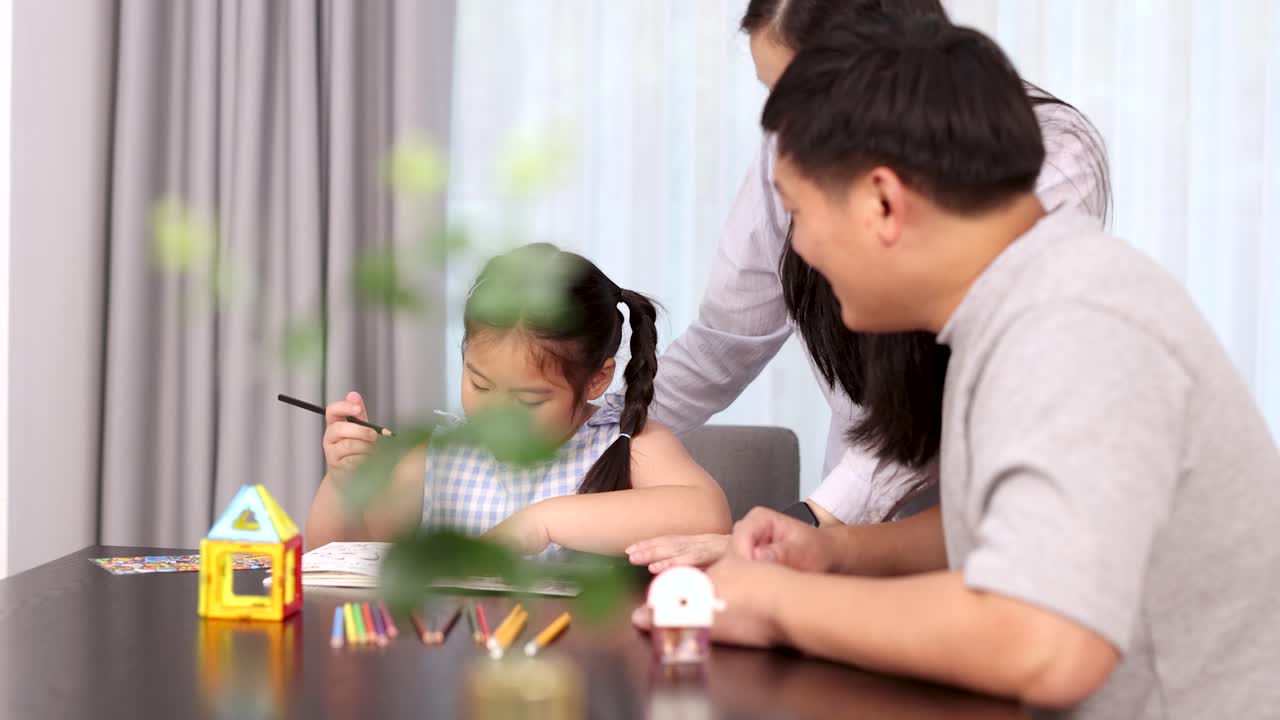 Parents assist daughter with homework in bright living room, natural light, static medium shot