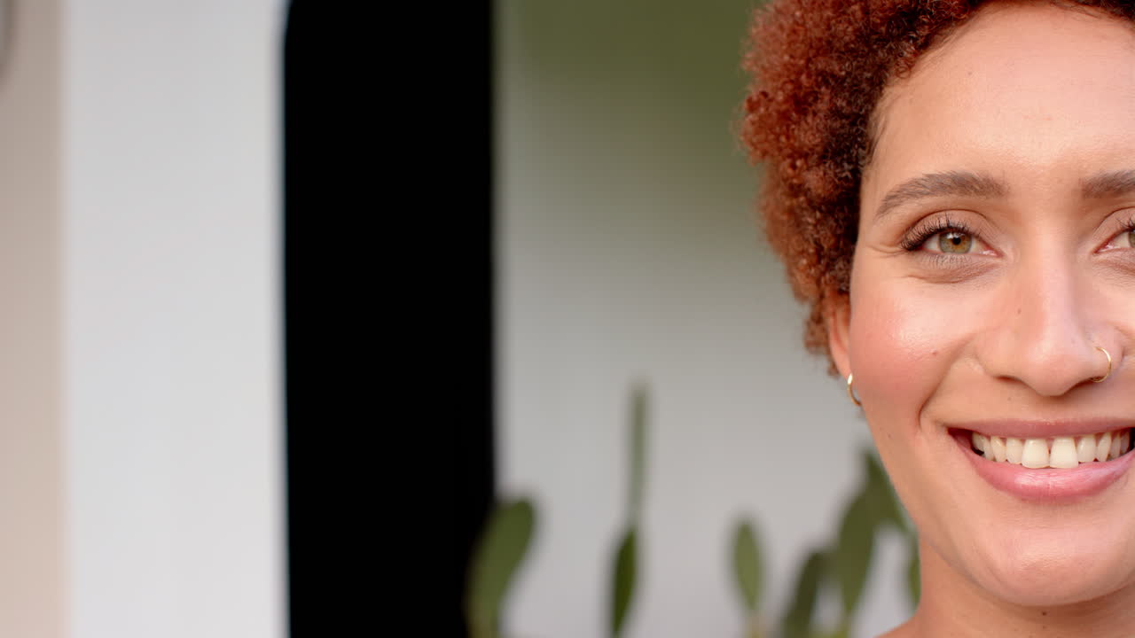 Smiling woman with curly hair enjoying outdoor hangout with friends, copy space