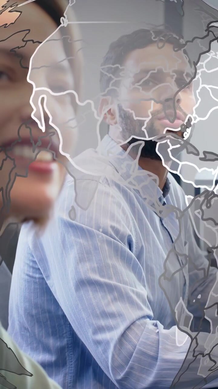 Vertical video: Presenter tapping man holding mug scanning biz papers as globe overlay rotating