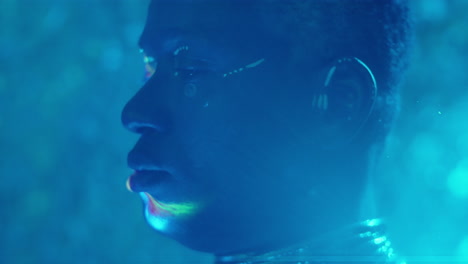 african american man with tribal makeup posing in laser light