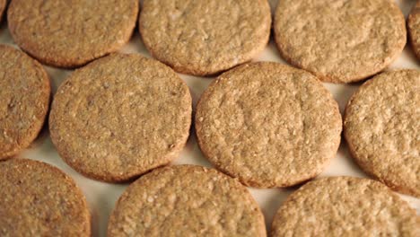 neatly folded oatmeal cookies rotate on a wooden board