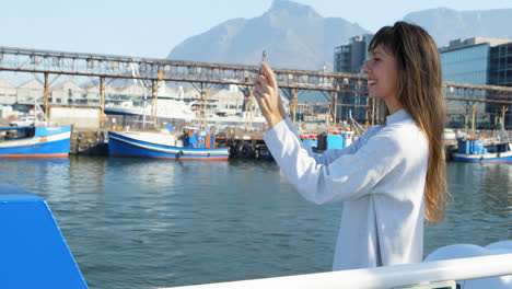 woman taking photo with mobile phone while travelling in ferry 4k