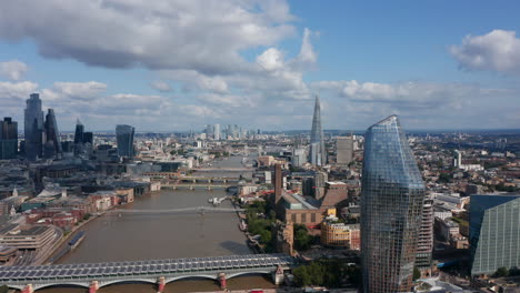 Fly-around-One-Blackfriars-tall-building-on-bank-of-River-Thames.-Aerial-panoramic-view-of-city-during-sunny-day.-London,-UK