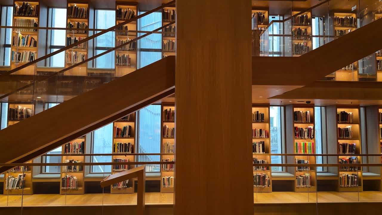 Elegant library with wooden shelves and modern glass design at Ataturk Cultural Center in Istanbul