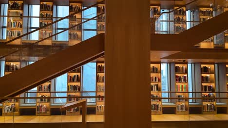 elegant library with wooden shelves and modern glass design at ataturk cultural center in istanbul