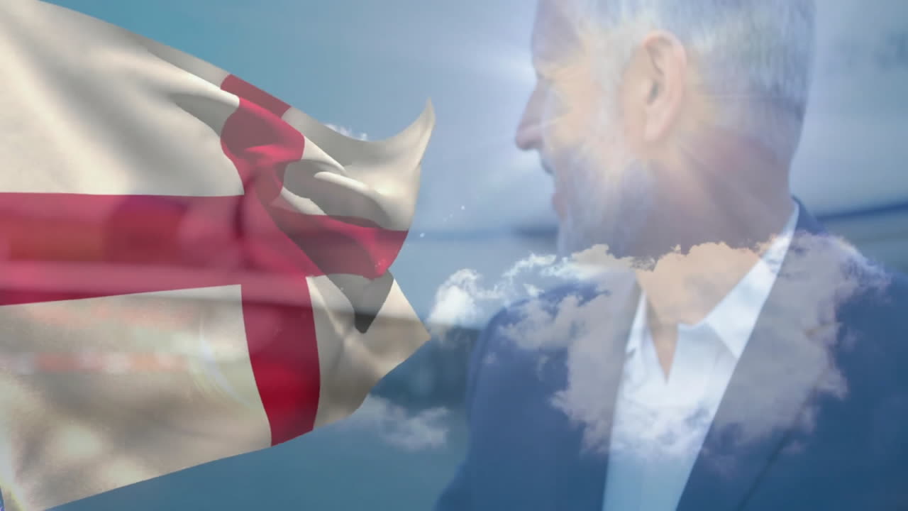 Waving English flag over man in suit with cloudy sky background
