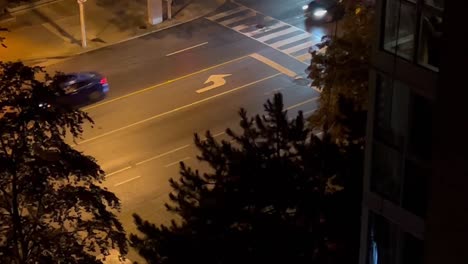 cars driving in the city street at night