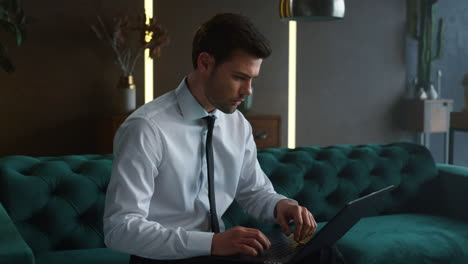 Businessman-typing-on-laptop-with-green-screen-at-office.-Man-working-on-laptop