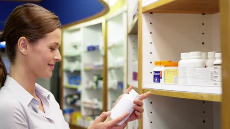 Pharmacist-checking-a-bottle-of-drug