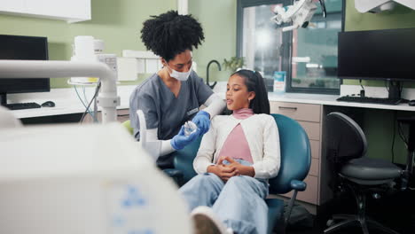 dentist explains dental model to young patient