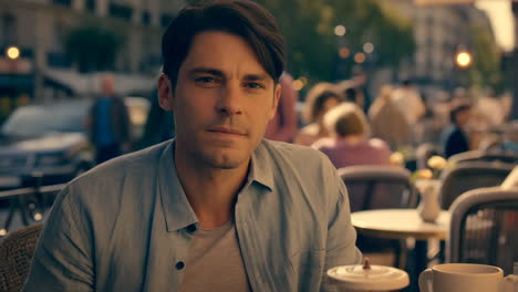 man sitting at outdoor cafe