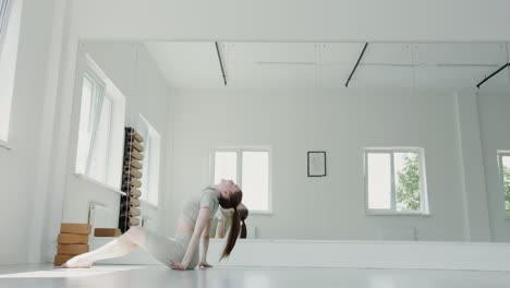 woman practicing yoga in a studio