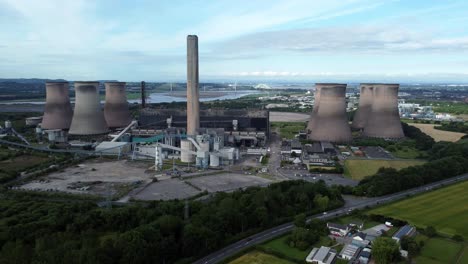 Fiddlers-ferry-power-station-aerial-view-cooling-towers-across-agricultural-farmland-crops-pull-back