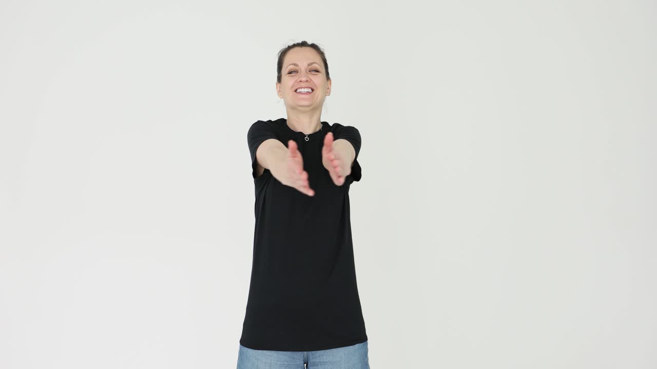 Woman in a black t-shirt with arms outstretched