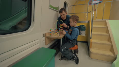 father and child in train play space