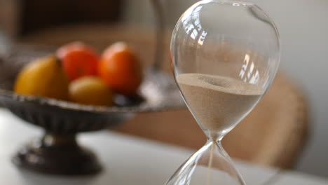 Hourglass-sand-falling-in-paning-shot