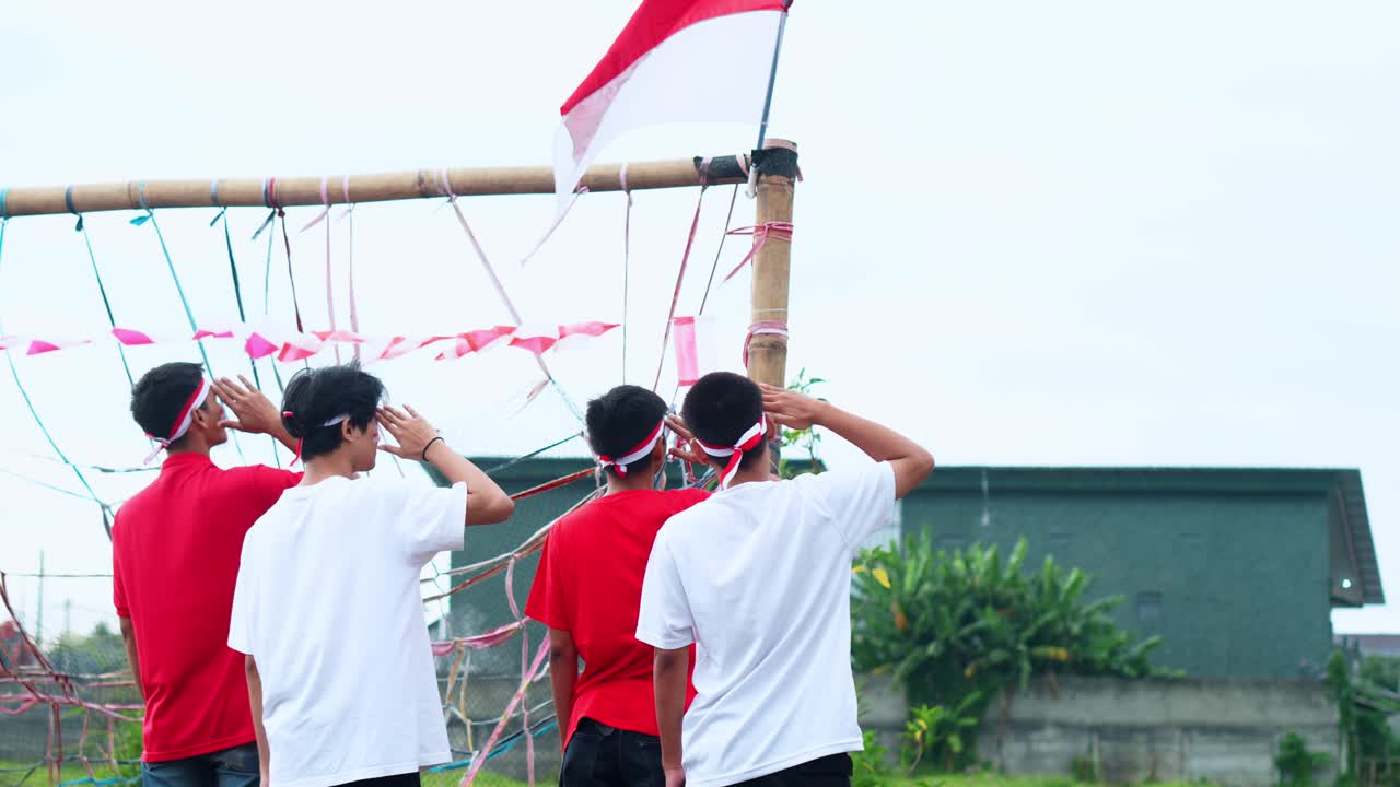 Group Of Young People Show Respect And Patriotism By Saluting The National Flag During Indonesian Independence Day Ceremony