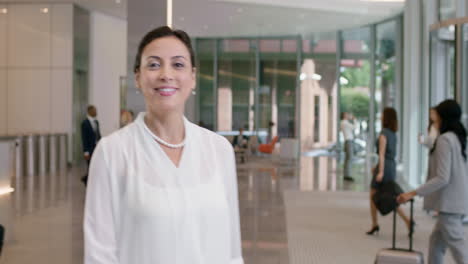 Portrait-of-Middle-Eastern-Business-woman-at-work-in-busy-office-lobby