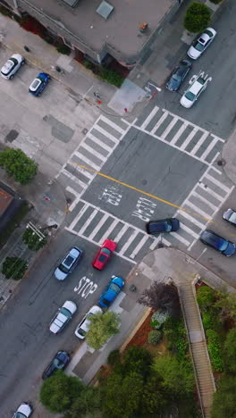 usual crossroads crossed by private cars in urban city. top view of the street in san francisco at daytime. vertical video