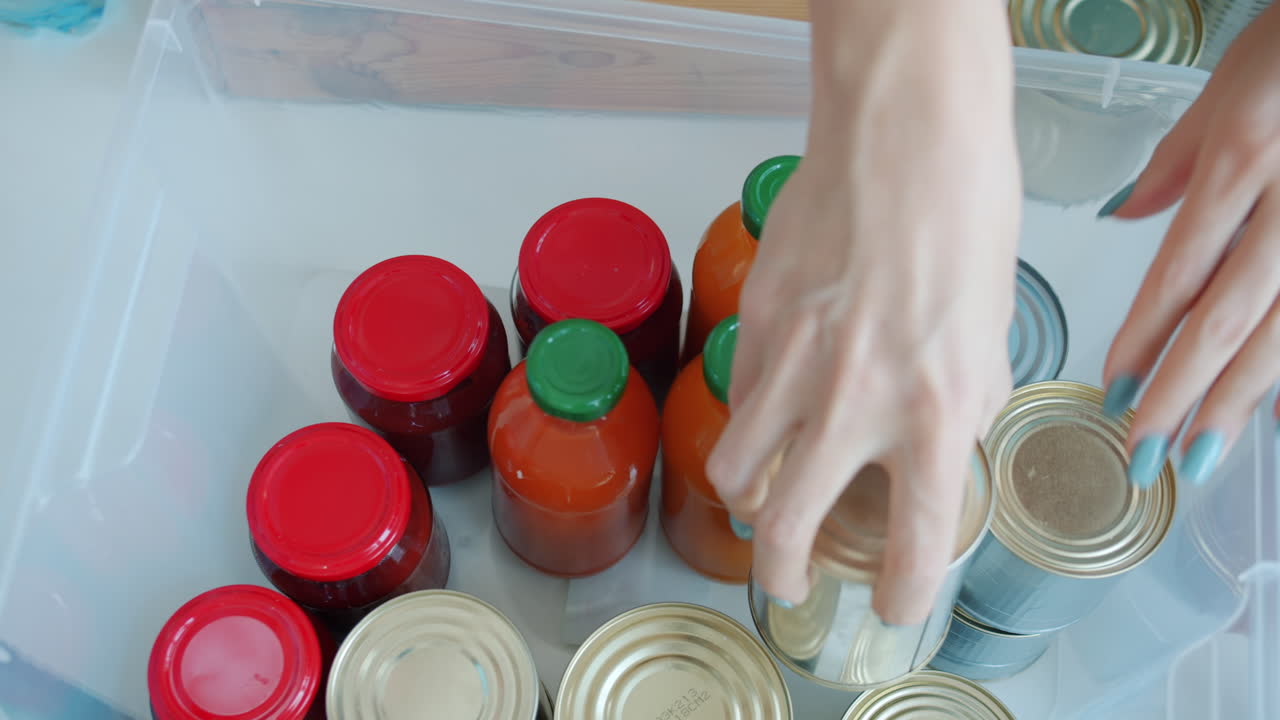 Organizing pantry with canned goods, jars, and bottles