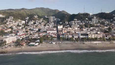 drone footage unveils the vibrant scene of the malecon boardwalk in puerto vallarta, mexico. this bustling seaside promenade becomes the central character in a lively tableau of beachfront city life