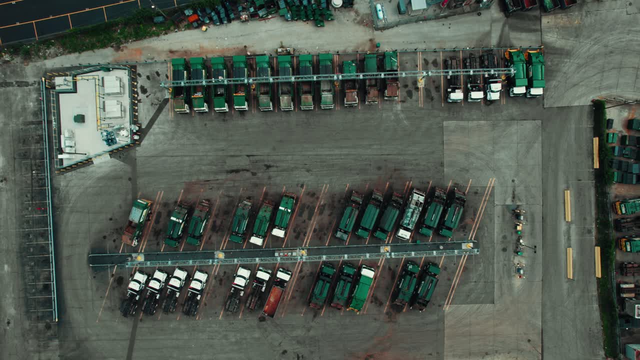 Bird eye aerial view over garbage trucks standing parked at parking lot