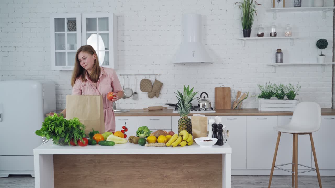 Woman cooking in kitchen. Portrait of smiling young housewife in modern kitchen
