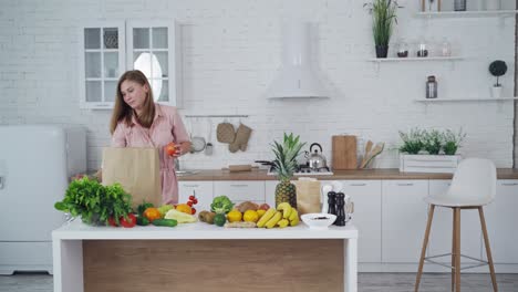woman cooking in kitchen. portrait of smiling young housewife in modern kitchen