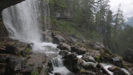 pan on waterfall of vallesinella and landscape with wood and valley, madonna di campiglio, trentino alto adige, italy