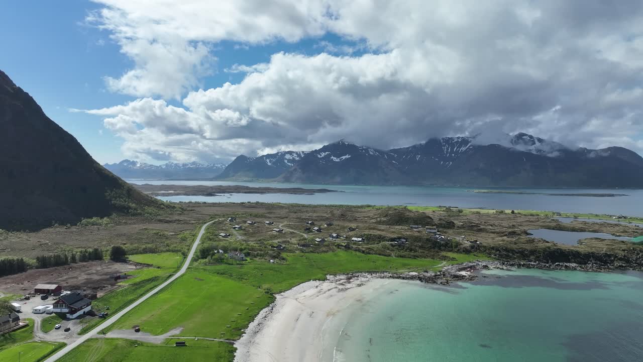Hov Beach on Gimsoy island, Lofoten, Norway, establishing aerial flight over shoreline, upscale rental cabins