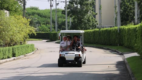 group of people enjoying a golf cart drive.