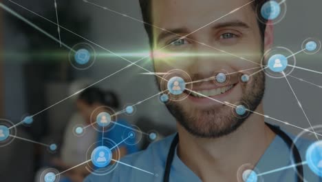 Animation-of-network-of-connections-with-icons-over-caucasian-male-doctor-smiling
