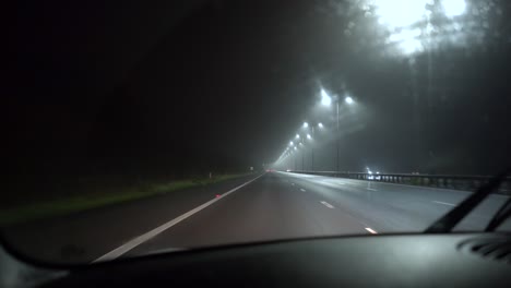 Handheld-footage-of-car-driving-on-an-empty-motorway---freeway-at-night