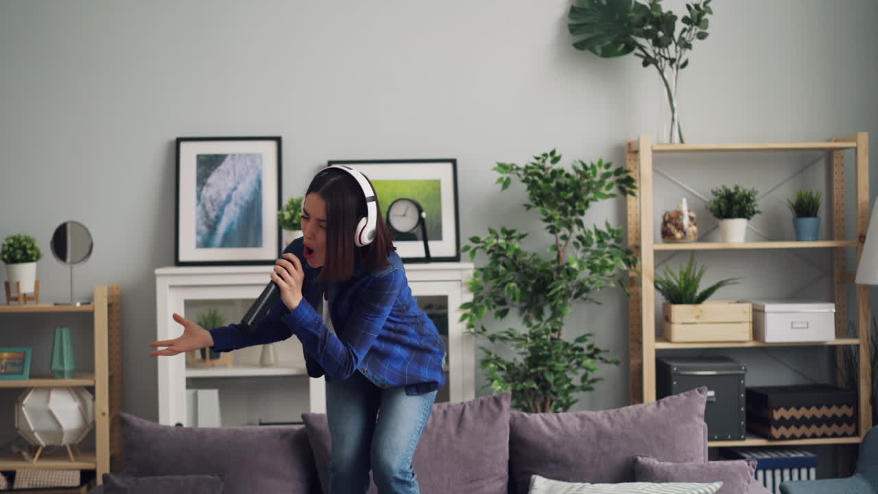 Woman Dancing in Living Room with Headphones